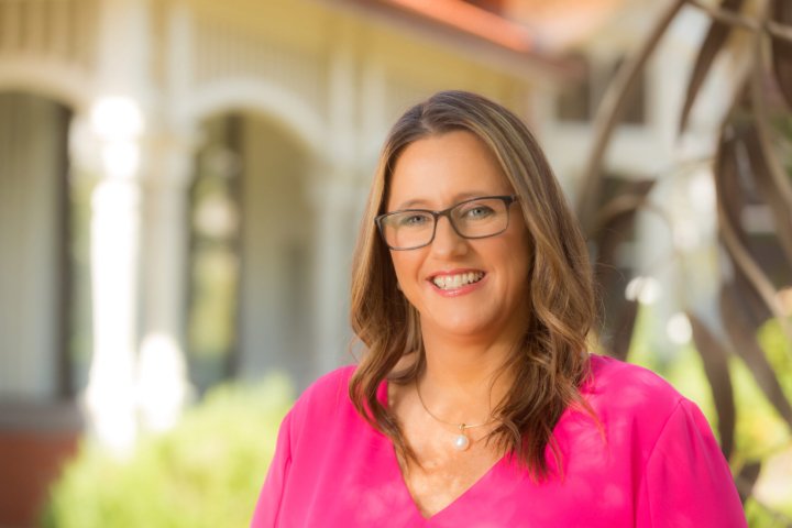 Female school teacher with eyeglasses wearing pink blouse