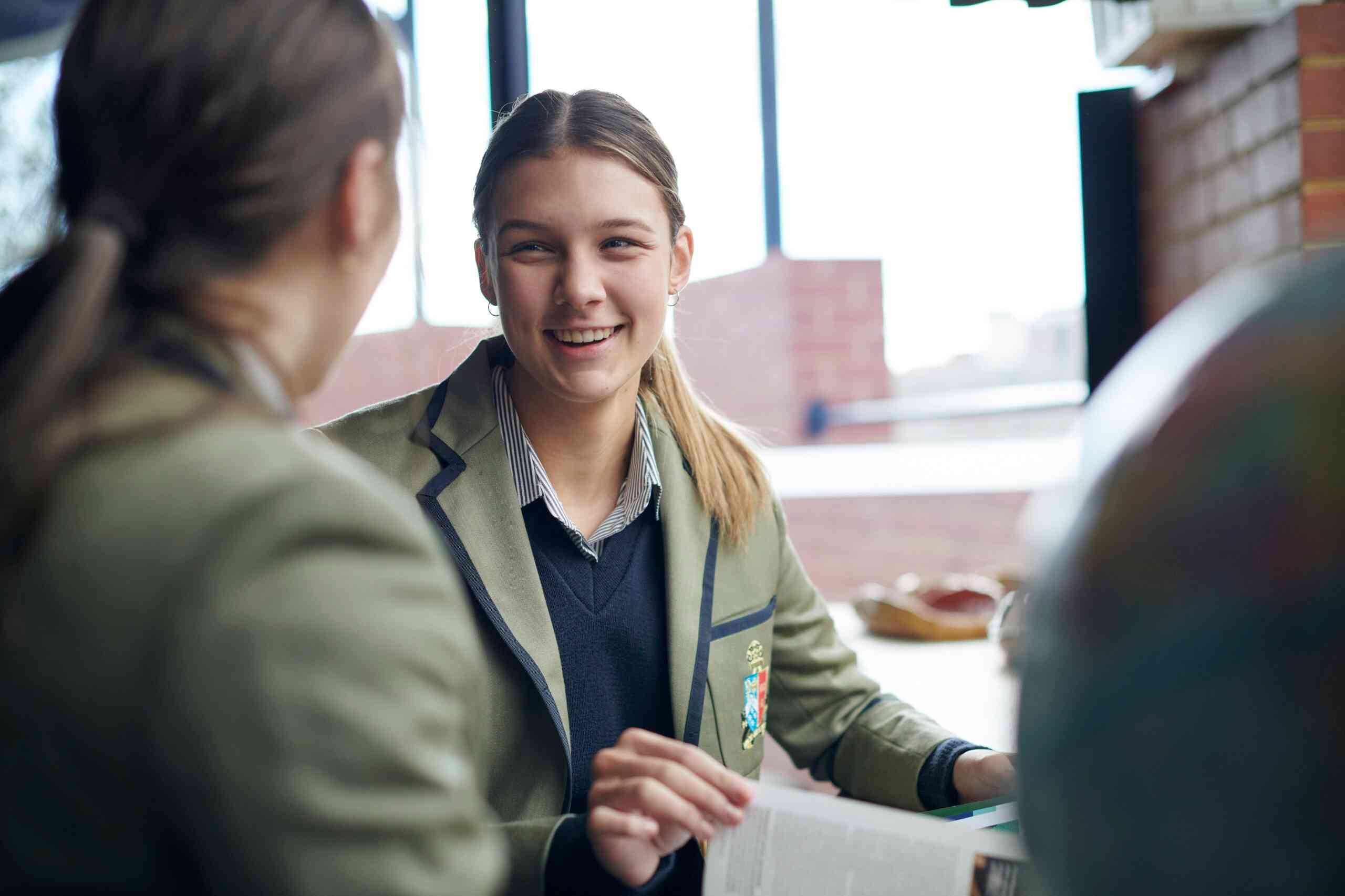 A female student smiling to her classmate